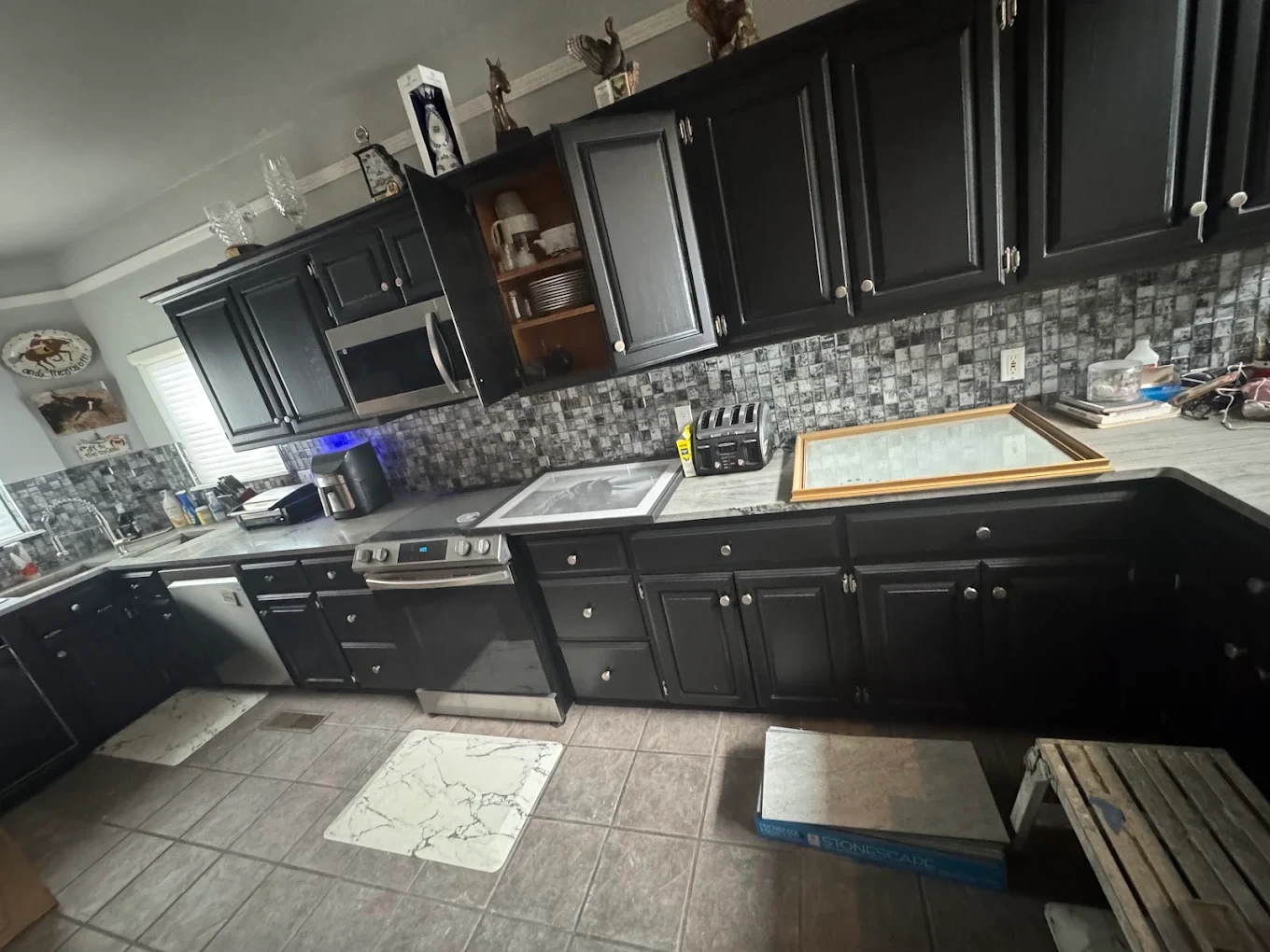Dark kitchen cabinetry and patterned backsplash