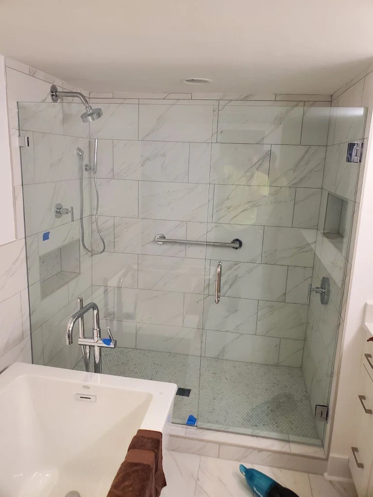 Glass shower enclosure and tile finishes