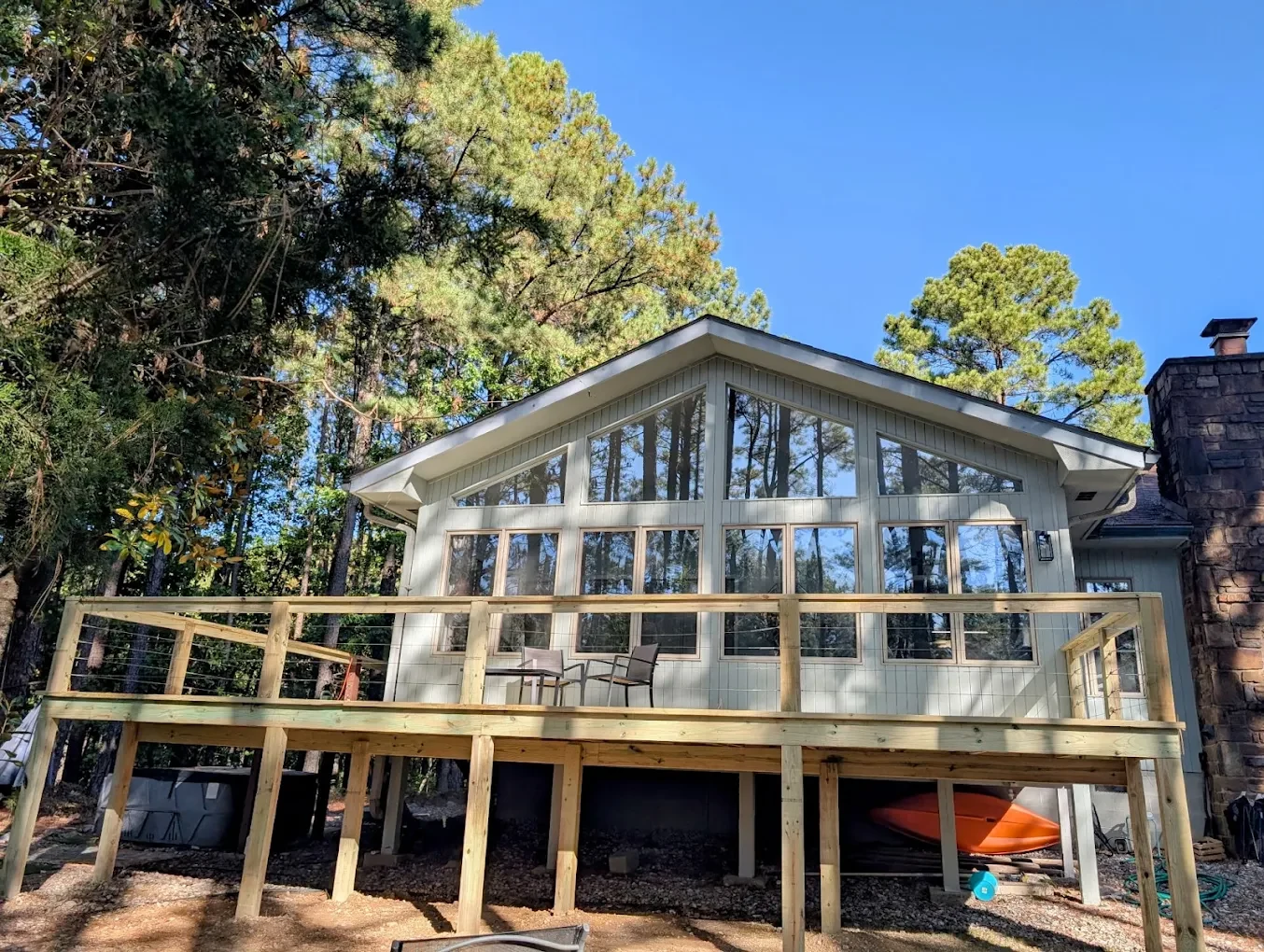 Window-lined home and elevated wood deck completed by Skeya