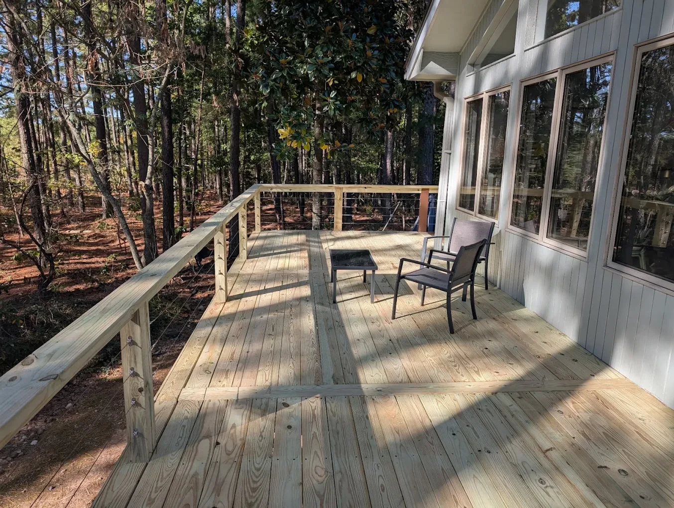Wood deck overlooking a wooded yard